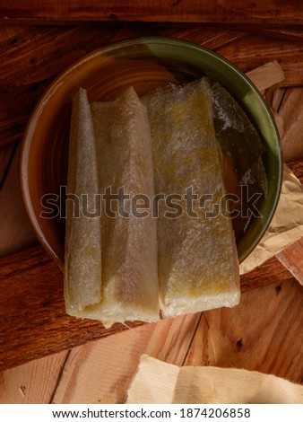 Home made traditional Indian sweet Pootharekulu on a rustic wooden background selective focus