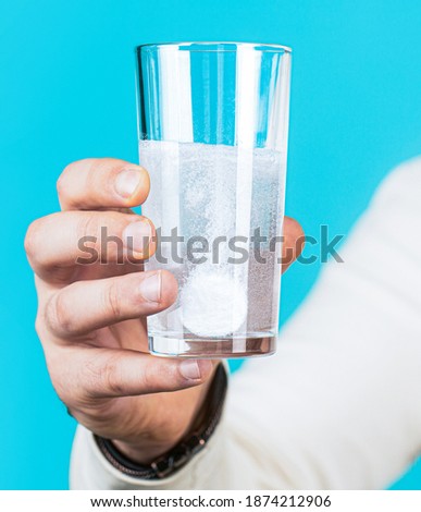 Glass of water tablet. Glass with efervescent tablet in water with bubbles.