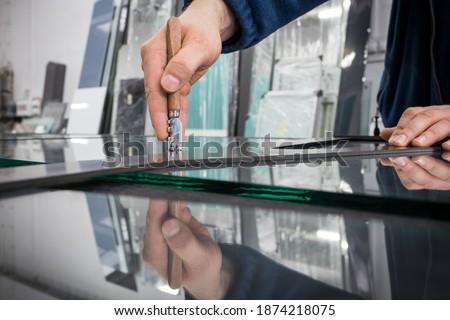 The glazier cuts the glass Royalty-Free Stock Photo #1874218075