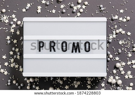 Text Promo on the lightbox on trendy gray background top view. Festive sale concept.