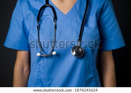 Young girl doctor in a suit and with a stethoscope. Medicine and healthcare