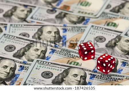 Two dices on money background - business concept. Shallow focus.