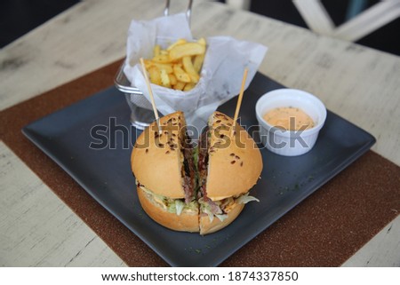 fresh delicious burgers with french fries and sauce, Fast food Delicious grilled burger, Homemade beef burger, Beef Burger and Fries with Garlic Sauce