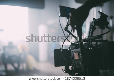 Professional film and video camera on the set. Shooting shift, equipment and group. Modern photography technique. Royalty-Free Stock Photo #1874338513