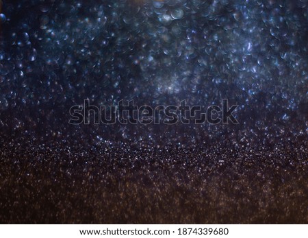 background of abstract glitter lights. Gold, blue and black. de focused. Bokeh