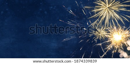 Silvester party New year background banner panorama long- sparklers and bokeh lights on dark blue night sky texture, with space for text Royalty-Free Stock Photo #1874339839