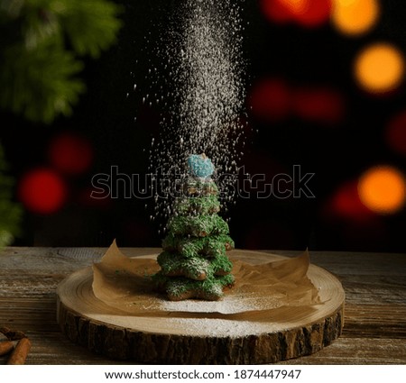 Christmas composition. Gingerbread spruce. Christmas wreath. Against the background of blurred festive garlands.selective focus. High quality photo. 