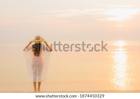Portrait beautiful young asian woman relax smile leisure around outdoor sea beach ocean at sunset time for vacation