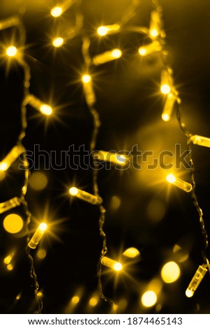 Neon illuminating wreath lights in color of the year 2021. Festive yellow festoon backdrop for greeting cards with text space