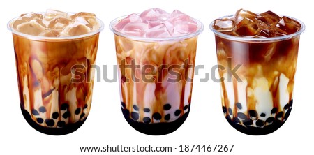Bubble Milk Tea - A plastic glass of fresh milk with black sugar syrup (Kuromitsu) and hot black pearl (Boba) on White Background, Taiwanese drinking culture Royalty-Free Stock Photo #1874467267