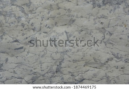   The surface of natural stone with cracks and inclusions                             
