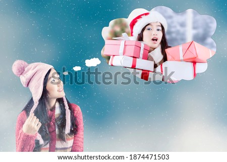 Picture of beautiful teenage girl imagining her getting many gift boxes at Christmas celebration