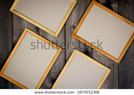 Mock up empty wooden frames on dark pine wood wall background, show text or product.