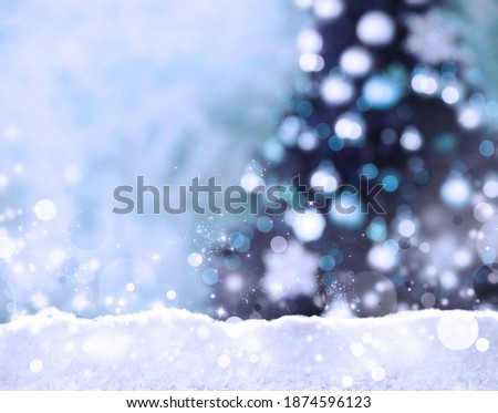 Snow and blurred view of beautiful decorated Christmas tree. Bokeh effect