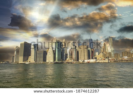 Downtown Manhattan skyline from Brooklyn Bridge Park - New York City at sunset.