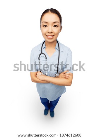 medicine, profession and healthcare concept - happy smiling asian female doctor or nurse in blue uniform with crossed arms over white background