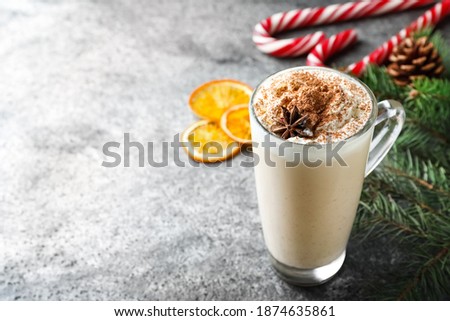 Delicious Christmas cocktail with liqueur on grey table. Space for text