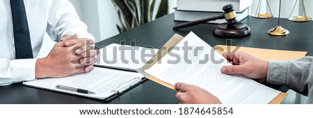 Male lawyer discussing negotiation legal case with client meeting with document contact in courtroom, law and justice concept. Royalty-Free Stock Photo #1874645854