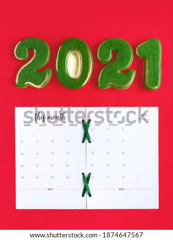 January month calendar, green with golden gingerbread in a shape of numbers 2021, red background