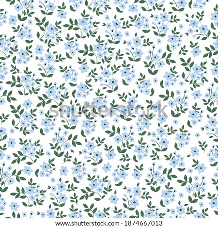 Elegant floral pattern of a small pale blue flower. White background. The style of freedom. Floral seamless background for fashion prints. Print color in a flower. Seamless vector texture.
