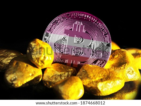 Bitcoin is marked with the flag of lesbian pride, against the background of gold ore