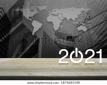 2021 start up business flat icon on wooden table over black and white world map with modern city tower and skyscraper, Happy new year 2021 cover concept, Elements of this image furnished by NASA