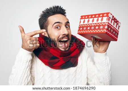 emotional man in checkered scarf with a gift in his hands holiday close-up