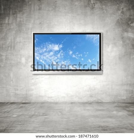 wide screen TV with sky on wall in room