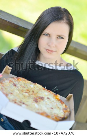 Girl eating a delicious pizza