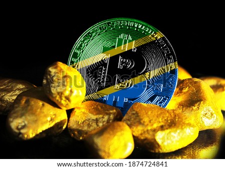 Bitcoin is marked with the flag of Tanzania, against the background of gold ore