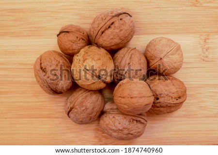 background of mountains walnut on wooden Board. pile of raw walnuts.