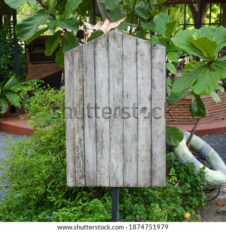 old plank wooden signboard in the garden