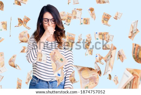 Beautiful young brunette woman wearing casual clothes and glasses feeling unwell and coughing as symptom for cold or bronchitis. health care concept.