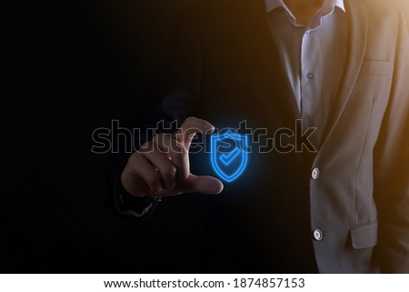 Protection network security computer in the hands of a businessman. business, technology, cyber security and internet concept - businessman pressing shield button on virtual screens Data protection.