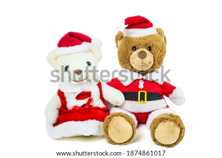 Couple teddy bear doll wearing santa set sitting isolated on white background,Christmas day and New Year's gifts