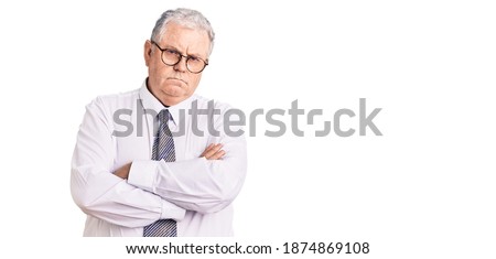 Senior grey-haired man wearing business clothes skeptic and nervous, disapproving expression on face with crossed arms. negative person.  Royalty-Free Stock Photo #1874869108