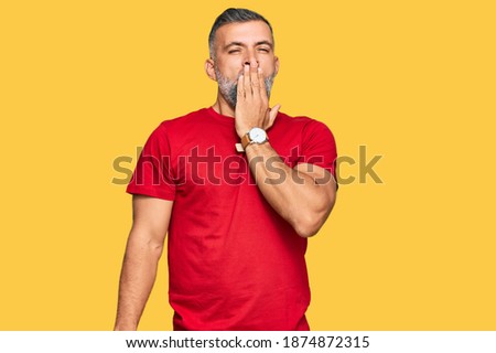 Middle age handsome man wearing casual clothes bored yawning tired covering mouth with hand. restless and sleepiness. 