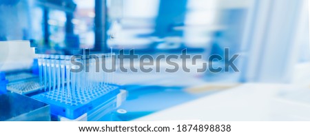Robotics technology background. blue 96 well roboter head in genetics and medical laboratory. Medical diagnostics and research in futuristic fourth industrial revolution. Banner with free space Royalty-Free Stock Photo #1874898838