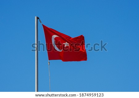 Waving flag of Turkey under sunny blue sky