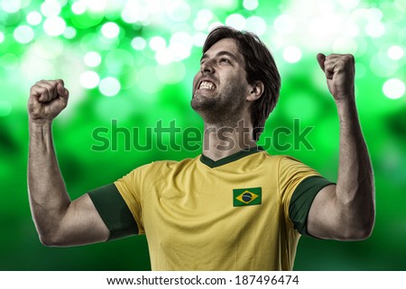 Brazilian soccer player, celebrating on a green lights background.
