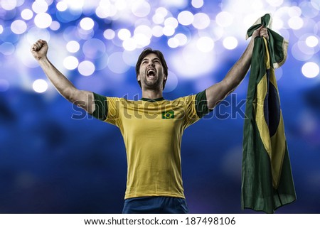 Brazilian soccer player, celebrating on a blue lights background.