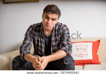 guy in a plaid shirt on the couch