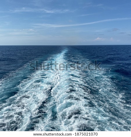 The churning blue water of a cruise ship wake on the Atlantic Ocean.  
