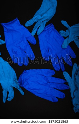 Blue Gloves on black background