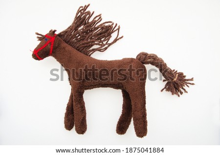 Brown soft horse toy isolated on white background