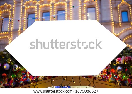 Mockup image: blank street shop white signboard with Christmas garland toy decor, blurred warm bokeh background - close up. Holiday, mock up, copyspace, New Year, template concept
