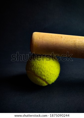 tennis ball with wooden baseball bat