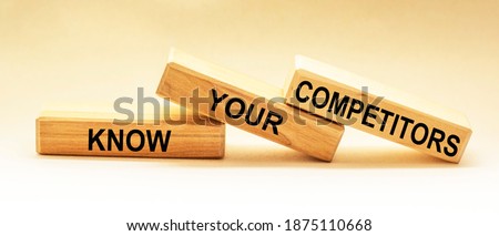 On wooden blocks the text KNOW YOUR COMPETITORS concept of business success. Royalty-Free Stock Photo #1875110668