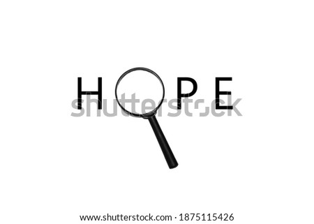 Inscription "Hope" with magnifying glass instead of the letter O on white background with blank copy space. In search of hope, faith concept. Minimalistic image. Flat lay