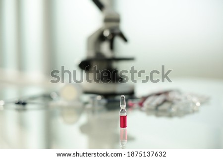 Stethoscope ampoule pill microscope on glass table